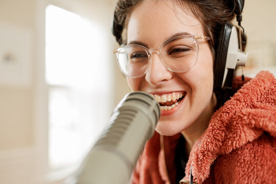 smiling young woman recording a podcast