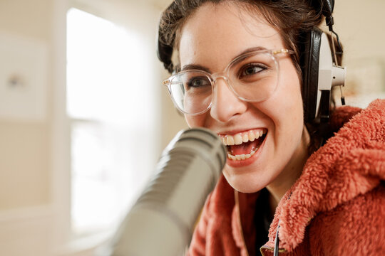 happy young woman podcasting