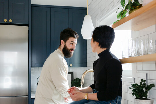 Couple Talking and Doing Dishes