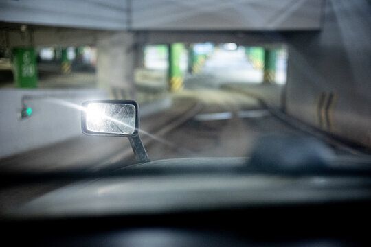 Fototapeta Point of view of a driver with light reflected on the rearview mirror