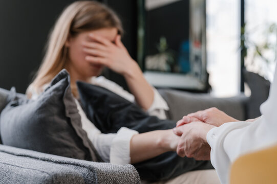 Crop psychologist supporting crying patient during session