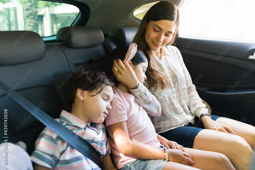 Wall mural Cute kids falling asleep in the back of the car