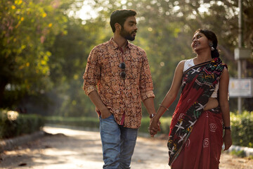 young Indian couple walking in a park
