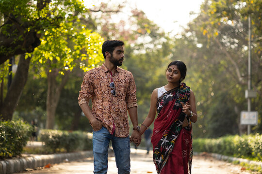 Young Indian Couple Walking In A Park