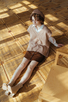 Retro woman sitting on wooden floor
