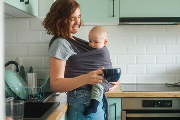 Woman With Baby Drinking Coffee In The Kitchen