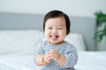 Asian baby girl is smiling and laughing