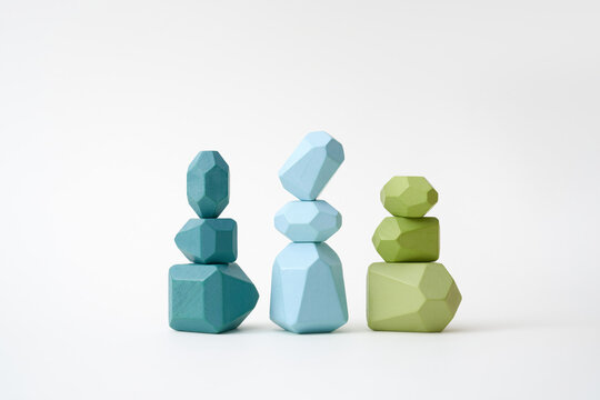 Stacks of balanced blue and green wooden pieces
