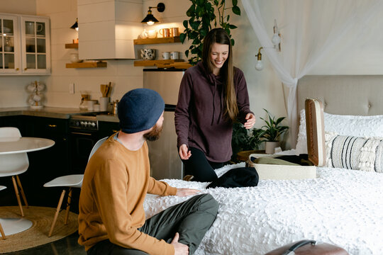 Laughing Couple Packing for Vacation