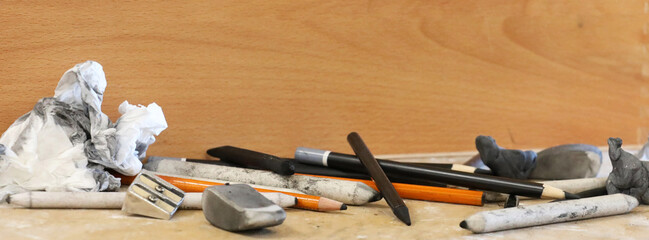 A wide shot a of a range of traditional, used artists drawing media and materails. Equipment an artist would used for life drawing, still life of landsacpe at school college or in the studio.