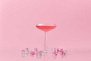 Drink in glass and flowers in cubes