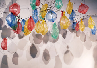 Colorful plastic bags tied to the branches to make a decorative background. Indoor activities