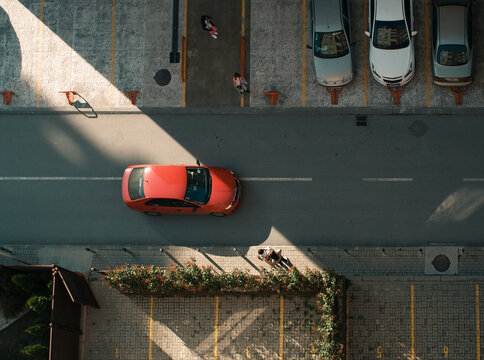 Red Car And Diagonal Shadow