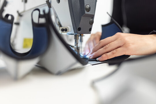 Young woman working with sewing machine
