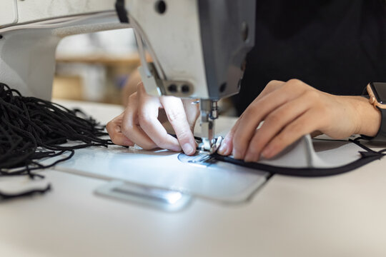 Young woman working with sewing machine