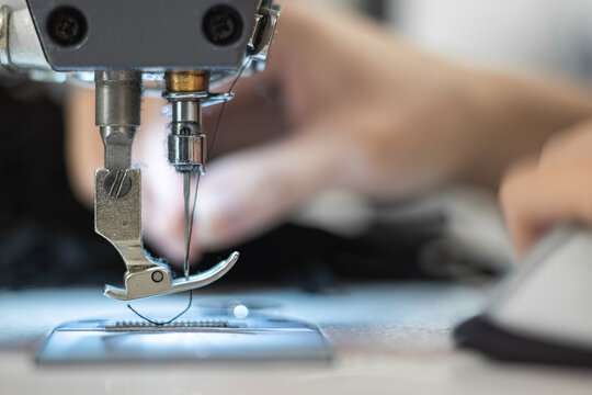 Young woman working with sewing machine