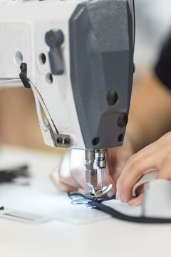 Young woman working with sewing machine