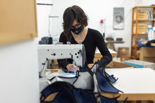 Young woman working with sewing machine