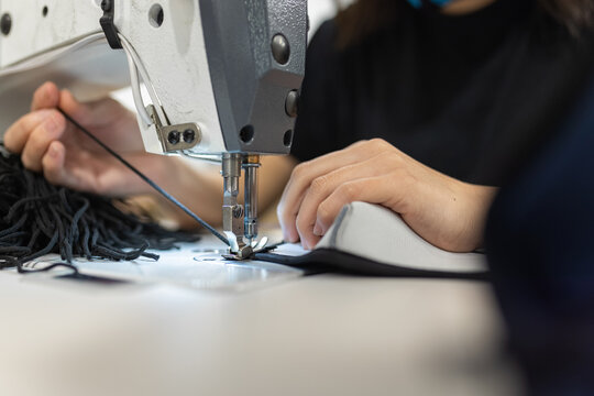Young woman working with sewing machine
