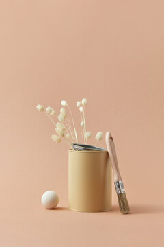 Tin of beige paint and twigs