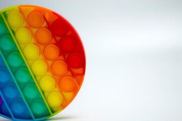 The most fashionable sensory toy. New popular colorful hexagon-shaped pop it anti-stress toy. Toy fidget Rainbow Pop, place for text