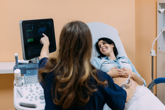Female doctor performing a  ultrasound to a patient