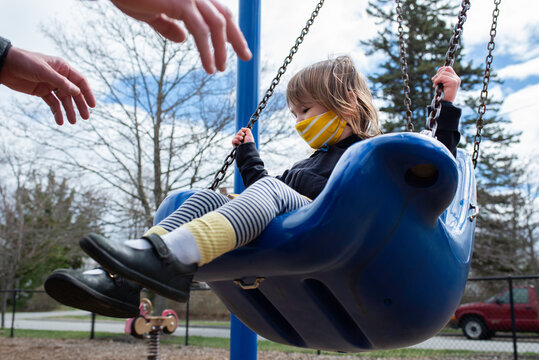 Young Girl on on the Swing at the Playground