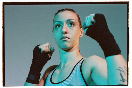Strong woman in sportswear standing in fighting stance