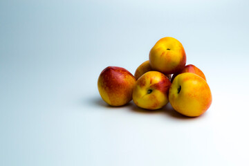 Naklejka na ściany i meble One nectarine lies on a monochrome background. Dietic protact, a product of ancient people.