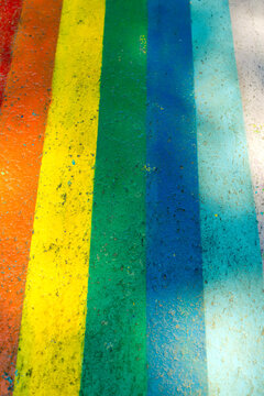 rainbow colors painted on wall in urban setting