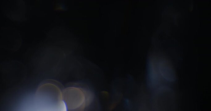 Seamlessly looped bokeh lights with colorful reflections shot with a vintage cinema lens for use as an overlay in any NLE