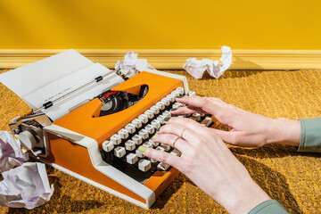 Stylish Yellow hands typing on Typewriter