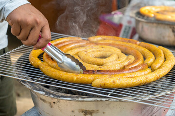 Grilled Isan sausages, tongs, charcoal grills