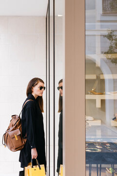 Woman stands in front of the shop window