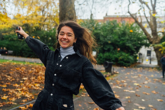 Woman taking Pictures of Autumn with an Old Camera