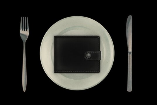 Money wallet on a plate with cutlery