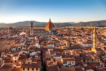 Fototapeta na wymiar Florence, Italy - 20 June, 2019 : sunset view of Cathedral of Santa Maria del Fiore, known for its red-tiled dome, overview from Arnolfo Tower (Torre di Arnolfo) - 95m-tall medieval tower.