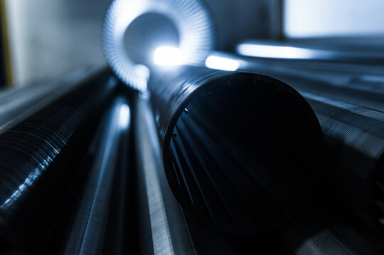 Stack of metallic tubes backlit by the flash