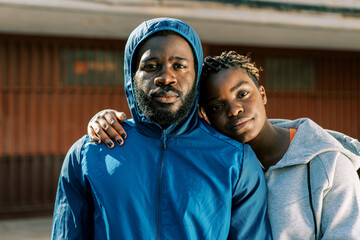 Sporty couple in warm activewear standing on street