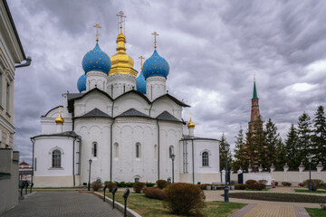 Fototapeta na wymiar Annunciation Cathedral of the Kazan Kremlin and Suyumbike Leaning Tower in the background on a cloudy spring day Tatarstan, Russia.