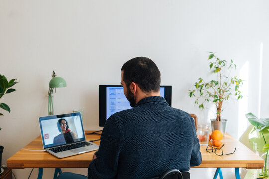 Young adult man having a business video call conversation 