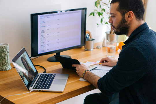 Young adult man having a business video call conversation 