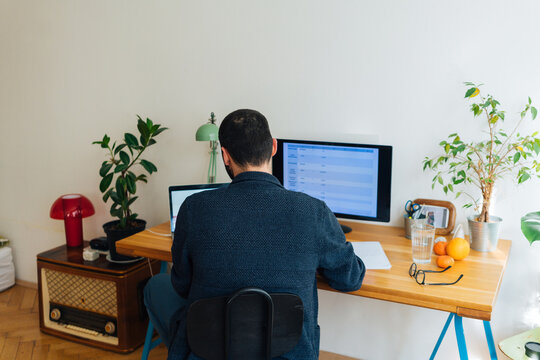 Unrecognizable young adult man at home office