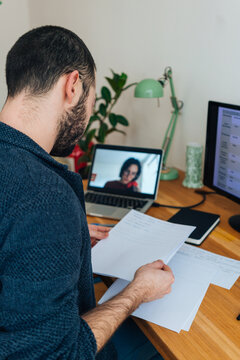 Young adult man having a business video call conversation 