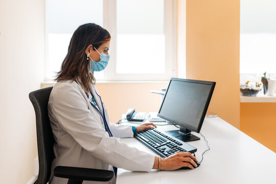Real female doctor using a computer in the hospital office
