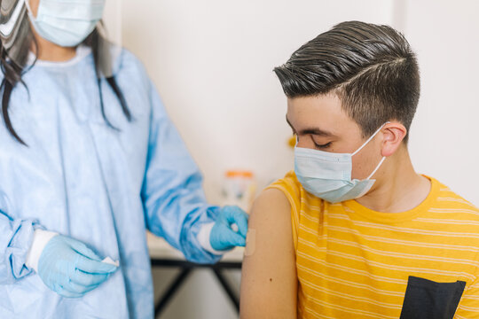 Doctor putting patch on arm of patient after vaccination