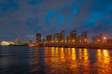 Fototapeta na wymiar City of Miami Florida, sunset panorama with business and residential buildings and bridge on Biscayne Bay. Skyline night view.