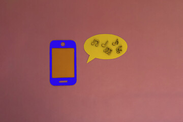 The phone is blue, an oval for text, wooden notes on a pink background. Listening to music,...