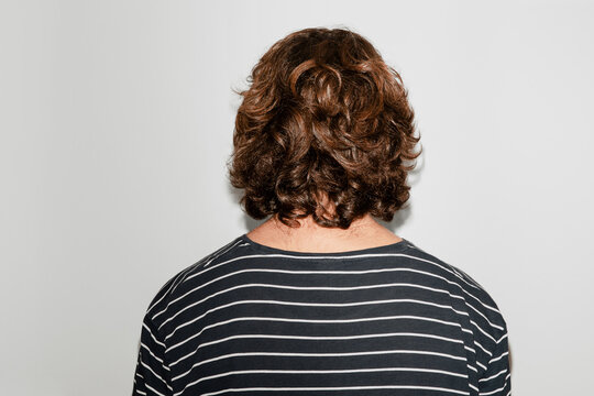 Back view of a curly man
