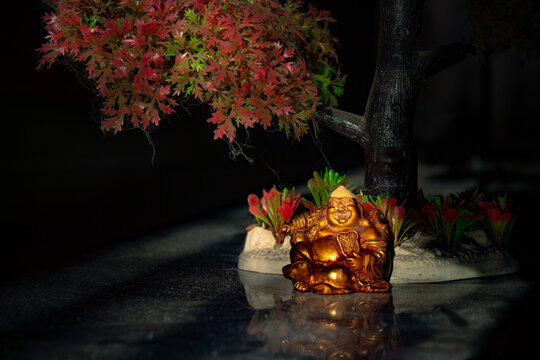 Laughing Buddha Statue on under the Tree. Statue of Laughing Buddha. Statue of kubera.